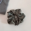 Detail of dark grey velvet scrunchie showing soft fabric texture and elastic pleats - Moss Green
