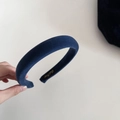 Detail shot of navy blue velvet sponge headband showing plush texture and inner label - Wide Version / Grey Blue