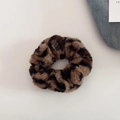 Macro shot of plush leopard print scrunchie showing soft faux fur texture and pattern - Dark Coffee Leopard