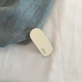 Close-up of beige acetate hair clip featuring the FRANCE Handmade engraved lettering - White