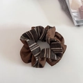 Detailed view of brown striped knitted scrunchie on a white minimalist background - Coffee
