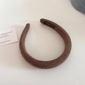 Close-up of coffee brown knitted sponge headband with metallic thread and inner label - Coffee