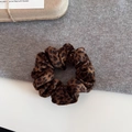 Detailed view of brown leopard print velvet scrunchie on a soft knitted background - Classic Leopard Print Plush Style / 3# Leopard Print