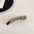 Close-up of a marble patterned acetate banana hair clip on a minimalist background - 1# Beige Coffee