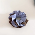Detail of blue and brown dual-color scrunchie with a stylish brand woven label - Light Blue Coffee