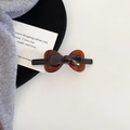 Detail view of a tortoiseshell acetate bow hair clip with glossy finish and metal base - Hair Clip (2#) / Brown