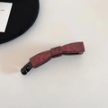 Detail of red marble texture acetate bow banana hair clip with secure black plastic clamp - Dark Red Marble