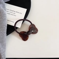 Detail of a brown acetate tortoiseshell bow hair tie on a minimalist white table setting - Hair Tie (6#)