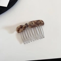 Detailed view of tortoiseshell acetate hair comb with golden glitter and silver metal teeth - Brown Hair Comb