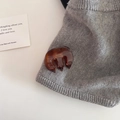 Detail showing amber tortoiseshell claw clip with gold lettering on grey knit fabric - 5# Coffee