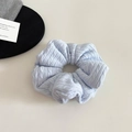 Detail of light blue chunky knit hair scrunchie with cable stitch texture and fluffy design - Large / Light Blue