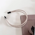 Close-up of double-layered champagne satin headband with comfortable anti-slip tips - 1# Creamy White