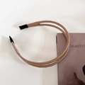 Detailed view of khaki double-layer satin headband with protective ends on modern props - Khaki