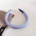 Detailed view of blue striped fabric headband with classic preppy pattern and woven label - Light Blue Wide Headband