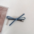 Détail d'une pince à cheveux nœud en denim bleu avec clip en métal argenté à l'arrière - Bleu Clair