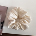 Close-up of a large cream-colored satin scrunchie with a soft silk texture and elegant folds - 1# Creamy White