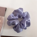 Primer plano de coletero grande lila con acabado brillante sobre superficie blanca suave - Azul Polvoriento