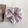 Close-up of a large purple and white striped scrunchie with soft seersucker texture - Purple