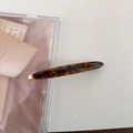 Detail of acetate tortoise hair clip with gold Barrette La France engraving and marble pattern - Blue Coffee
