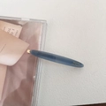 Close-up of Morandi blue acetate hair clip featuring gold Barrette La France lettering - Blue