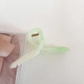 Detailed close-up of light green acetate hair claw clip with golden metal spring - No.7 Gradient Green - Cross Style