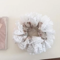 Close-up of pink floral scrunchie with layered white lace trim and elastic fabric detail - Beige