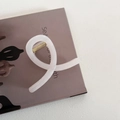 Macro detail of creamy white jelly hair claw clip with golden metal spring on magazine - Cross Style - Beige