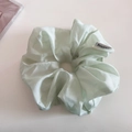 Detailed macro view of mint green organza scrunchie with subtle pearlescent shimmer finish - Mint Green