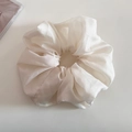 Detail of elegant cream organza scrunchie with soft sheen and delicate pleated texture - Beige Apricot