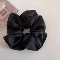 Close-up of black oversized scrunchie with subtle shimmer fabric and soft ruffled texture - Black