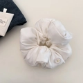 Detail of white cotton scrunchie with transparent button and golden bow embellishment - White