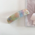 Close-up of acetic acid hair clip with marble texture and France handmade engraving - Rainbow