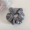 Detail view of a dark grey satin scrunchie with a soft silky glossy finish and elegant folds - 1# Gray Blue