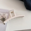 Close-up of cream hair claw clip with large square hollow handle and golden metal spring - Bar Style / Cream White