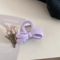 Detail of a light purple bow-shaped hair claw clip with metallic spring mechanism - Ribbon Bowknot / Creamy Purple