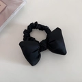 Close-up of black satin padded bow hair tie with smooth silk texture and elastic band - Black