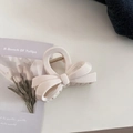 Close-up of a creamy beige ribbon bow hair claw clip with metallic spring components - Ribbon Bowknot / Cream White