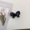 Macro shot of blue marble acetate butterfly hair clip with gold logo and crystals - 5# Ink Blue