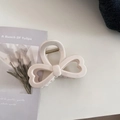 Detailed macro view of cream-colored bow hair claw clip with sturdy metal spring hinge - Heart Bow Style / Cream White