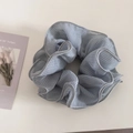 Close-up of blue gingham chiffon hair scrunchie with layered ruffle edge and texture - Blue