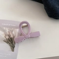 Close-up of lilac purple bow hair claw clip with metallic spring on a white surface - Small Bow Style / Taro Pink