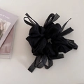 Detail of a black mesh scrunchie with soft organza bow ribbons for elegant hairstyles - Black