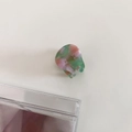 Detail view of small acetate hair claw with pink marble texture and gold France lettering - 4# Pink Green