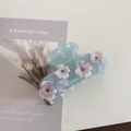Close-up of ice blue marble acetate hair claw with delicate rhinestone flowers - Ice Blue Flower Hair Claw
