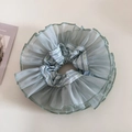Close-up of double-layer light green organza floral scrunchie with soft ruffled texture - Green