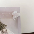 Detailed close-up of white marble pattern acetate hair claw clip with pearlescent finish - Mermaid White
