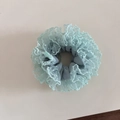 Detail showing light blue mesh scrunchie with white polka dots and lace trim edges - Green