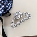 Close-up of acetic acid hair claw clip with black spotted pattern and floral rhinestone detail - Black and White Spotted Style / Polka Dot