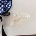 Detail of pearlescent acetate hair claw clip featuring rhinestone flower and logo - Iridescent Pearl White Style / Pearl White