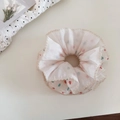 Detail of sweet chiffon scrunchie with colorful heart patterns and lace edging design - Rainbow
